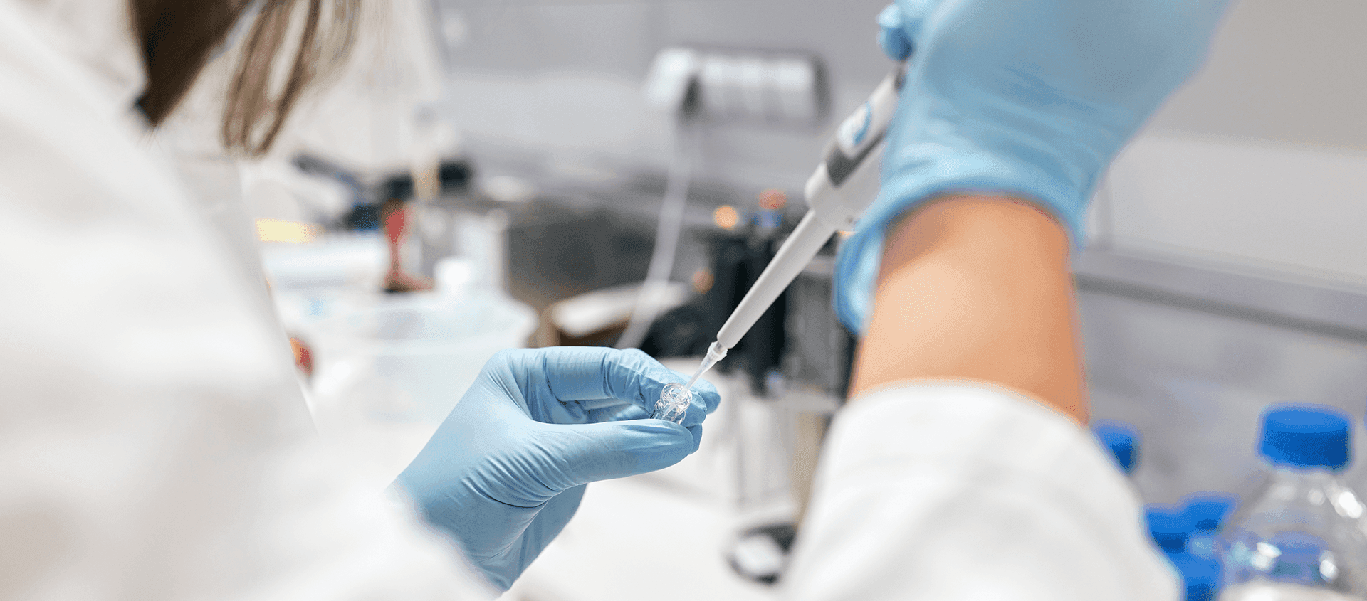 laboratory work, analyst pipetting a sample